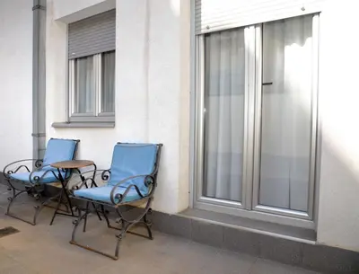 two chairs and a table next to a window at Studio Milan in Vračar (historical)