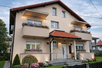 a house with flower boxes on the balconies at President 034 Deluxe in Arandjelovac